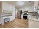 Spacious kitchen featuring white cabinets, stainless steel appliances, and a built-in desk area at 1904 Watercrest Cir, Lawrenceville, GA 30043