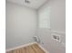 Practical laundry room with hardwood floors and window at 1904 Watercrest Cir, Lawrenceville, GA 30043