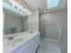 Modern main bathroom with double sink vanity, stylish fixtures and glass enclosed shower at 1904 Watercrest Cir, Lawrenceville, GA 30043