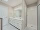 Main bathroom featuring a double sink vanity with shower behind a glass door at 1904 Watercrest Cir, Lawrenceville, GA 30043