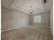 Large bedroom with tray ceiling, neutral walls, carpet flooring, and bright natural light at 1904 Watercrest Cir, Lawrenceville, GA 30043
