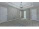 Large main bedroom with tray ceiling, carpet floors and multiple doors with access to other rooms at 1904 Watercrest Cir, Lawrenceville, GA 30043