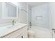 Bright bathroom features a tub, shower, and a sink with modern fixtures and white marble-like tile at 1914 North Nw Ave, Atlanta, GA 30318
