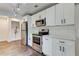 The kitchen features stainless steel appliances, a subway tile backsplash, and white cabinetry at 1914 North Nw Ave, Atlanta, GA 30318