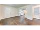 Bright living room featuring hardwood floors, white walls, and an open doorway into an updated kitchen and bathroom at 1914 North Nw Ave, Atlanta, GA 30318