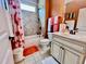 Well-lit bathroom with modern vanity, shower-tub combo, light fixtures, and ceramic tile at 245 Fenwick Cir, Mcdonough, GA 30253
