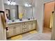 Bathroom with double sink vanity, large mirror, updated light fixtures, and neutral paint at 245 Fenwick Cir, Mcdonough, GA 30253