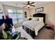 Cozy bedroom with neutral colors, carpet, ceiling fan, one window, and framed artwork at 245 Fenwick Cir, Mcdonough, GA 30253
