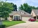 Inviting one-story home featuring manicured landscaping, stone detailing, and a paved driveway at 245 Fenwick Cir, Mcdonough, GA 30253