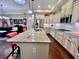 Elegant kitchen featuring white cabinets, granite countertops and an island with barstool seating at 245 Fenwick Cir, Mcdonough, GA 30253