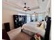 Spacious main bedroom featuring tray ceiling, carpet, ceiling fan, large bed and tv console at 245 Fenwick Cir, Mcdonough, GA 30253