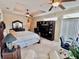 Spacious main bedroom featuring tray ceiling, carpet, ceiling fan, large bed and tv console at 245 Fenwick Cir, Mcdonough, GA 30253