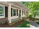 Inviting covered front porch with brick accents and black shutters offer curb appeal at 2826 Summit Ridge Dr, Marietta, GA 30066