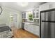 Bright kitchen featuring stainless steel appliances, granite counters, and white shaker cabinets at 2826 Summit Ridge Dr, Marietta, GA 30066