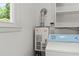 Close up of water heater and one laundry appliance in a clean laundry room at 2826 Summit Ridge Dr, Marietta, GA 30066
