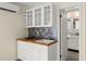 Close up of a modern kitchenette with white cabinets, butcher block counters, and tiled backsplash at 2826 Summit Ridge Dr, Marietta, GA 30066