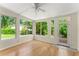 Bright sunroom featuring large windows, hardwood floors, and a ceiling fan at 2826 Summit Ridge Dr, Marietta, GA 30066