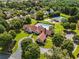 Gorgeous aerial view of a community clubhouse, pool, tennis courts, and lush landscaping at 2740 Greymont Ct, Cumming, GA 30041