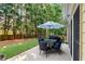 Outdoor patio with dining set and umbrella, perfect for entertaining with a serene backyard view at 2740 Greymont Ct, Cumming, GA 30041