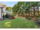 Spacious backyard offers plenty of room to play and relax surrounded by lush greenery at 2740 Greymont Ct, Cumming, GA 30041