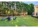 Backyard featuring a fire pit area and playground, ideal for Gathering fun and gatherings at 2740 Greymont Ct, Cumming, GA 30041