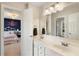 Bright bathroom featuring double sinks, white cabinetry, and a connecting door to the bedroom at 2740 Greymont Ct, Cumming, GA 30041
