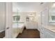 Elegant bathroom featuring a soaking tub, glass shower, and double vanity at 2740 Greymont Ct, Cumming, GA 30041