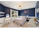 This bedroom features blue walls, a ceiling fan, and a cozy bed with a window view at 2740 Greymont Ct, Cumming, GA 30041