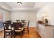 Elegant dining room featuring a tray ceiling, hardwood floors, and a stylish sideboard, perfect for entertaining guests at 2740 Greymont Ct, Cumming, GA 30041