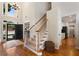 Grand foyer with hardwood floors, a staircase with wooden railings, and abundant natural light from a large window at 2740 Greymont Ct, Cumming, GA 30041