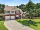 Beautiful two-story home featuring a brick facade, manicured lawn, and a two-car garage at 2740 Greymont Ct, Cumming, GA 30041