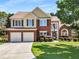 Beautiful two-story home with a brick facade, well-maintained lawn, and a two-car garage, perfect for Gathering living at 2740 Greymont Ct, Cumming, GA 30041