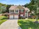 Attractive two-story residence with brick accents, a manicured front yard, and a convenient two-car garage at 2740 Greymont Ct, Cumming, GA 30041