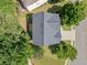 Aerial view of a home with dark roof surrounded by lush green trees and well-manicured lawn at 275 Springs Xing, Canton, GA 30114