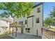 The back exterior features a deck, door to the basement, a patio, and many windows at 275 Springs Xing, Canton, GA 30114