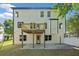 The back exterior features a deck, door to the basement, a patio, and several windows at 275 Springs Xing, Canton, GA 30114