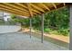 Stone patio beneath a wooden deck with gray support beams and a view of a wooded yard at 275 Springs Xing, Canton, GA 30114