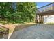 Backyard with a patio, stairs to a wooden deck and abundant shrubbery and trees at 275 Springs Xing, Canton, GA 30114