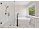 Modern bathroom featuring a glass-enclosed shower, soaking tub, and elegant fixtures at 275 Springs Xing, Canton, GA 30114
