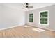 Bright bedroom featuring two windows, stylish ceiling fan, luxury vinyl flooring, and neutral paint for versatile decor options at 275 Springs Xing, Canton, GA 30114