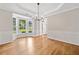 Sunlit dining room with hardwood floors, elegant wainscoting, tray ceiling and large bay window at 275 Springs Xing, Canton, GA 30114