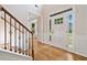 Bright foyer with hardwood floors, staircase with decorative iron spindles, and a view of the front door at 275 Springs Xing, Canton, GA 30114