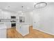 Bright kitchen offers a large island, stainless steel appliances, and hardwood floors at 275 Springs Xing, Canton, GA 30114