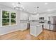 Bright kitchen boasts a large island, stainless steel appliances, and beautiful hardwood floors at 275 Springs Xing, Canton, GA 30114