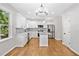 Modern kitchen with white cabinets, stainless steel appliances, a kitchen island, and hardwood floors at 275 Springs Xing, Canton, GA 30114