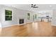 Open-concept living space with hardwood floors, fireplace, and seamless flow into the modern kitchen at 275 Springs Xing, Canton, GA 30114