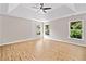 Open main bedroom with hardwood floors, large windows, and modern ceiling fan at 275 Springs Xing, Canton, GA 30114