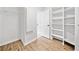 Spacious walk-in closet with wood-look flooring, built in shelves, and a wire rack for optimal storage and organization at 275 Springs Xing, Canton, GA 30114