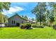 Well-maintained backyard with manicured lawn, lush landscaping, mature trees and privacy fence at 115 Edgewater Way, Peachtree City, GA 30269
