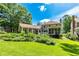 Large grassy backyard with lush landscaping, screened in porch, covered area and beautiful shade trees at 115 Edgewater Way, Peachtree City, GA 30269